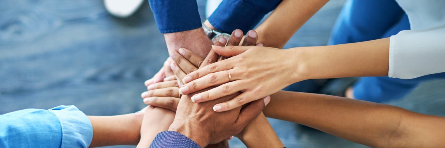 Let’s awaken the team spirit Cropped shot of a group of colleagues joining their hands together in unity